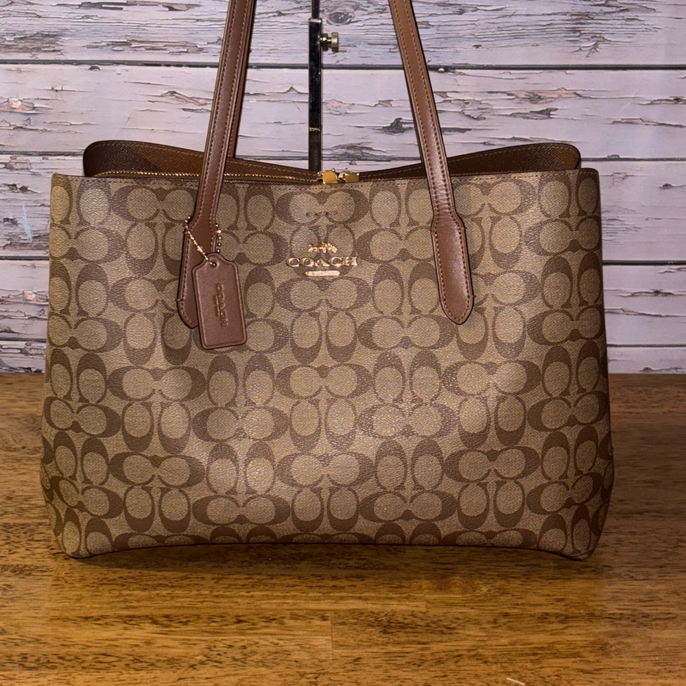 Coach large avenue carryall in signature designed coated canvas.